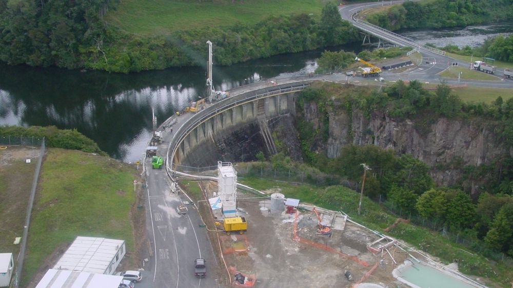 Aerial view of Arapuni Dam looking north with machinery on the bridge during the mid-2000s works
