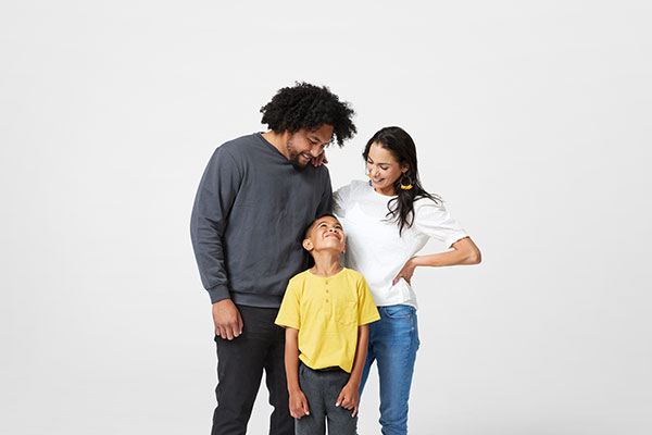 A family of three standing together.