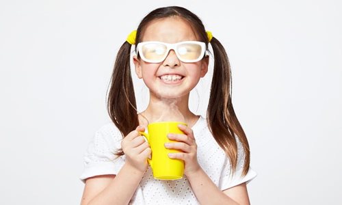 Girl holding yellow mug