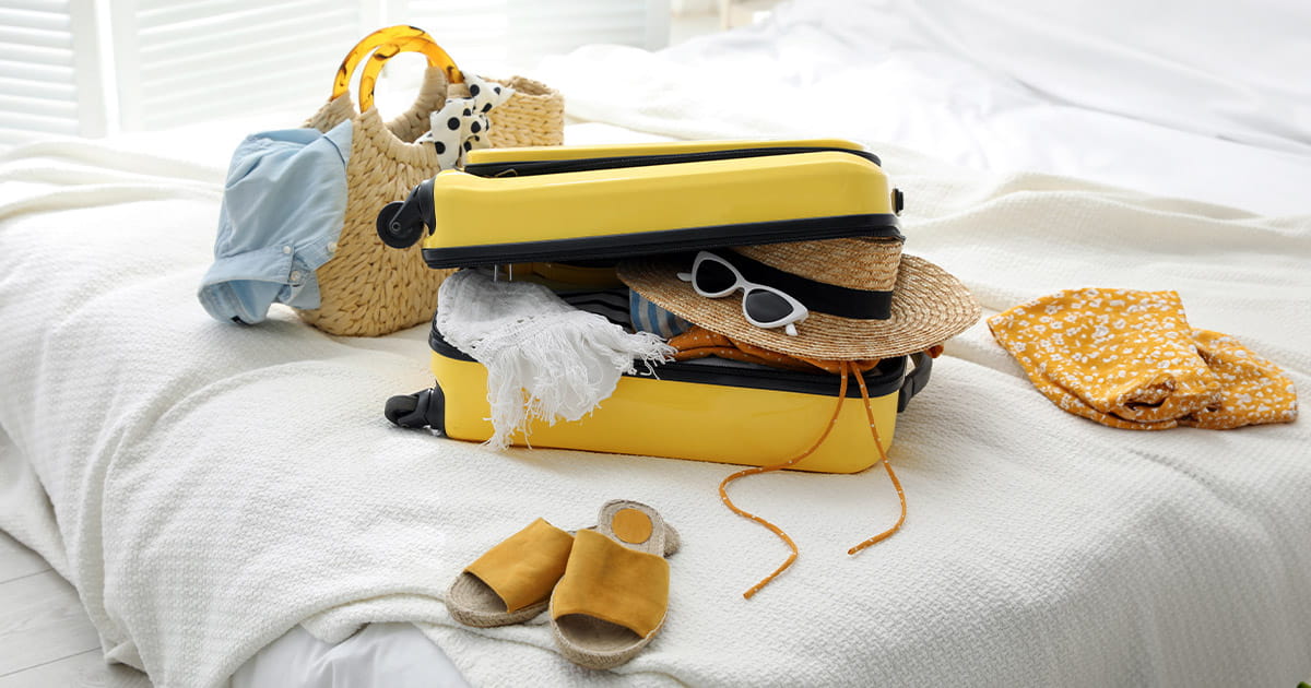 Yellow suitcase packed ready to go on holiday
