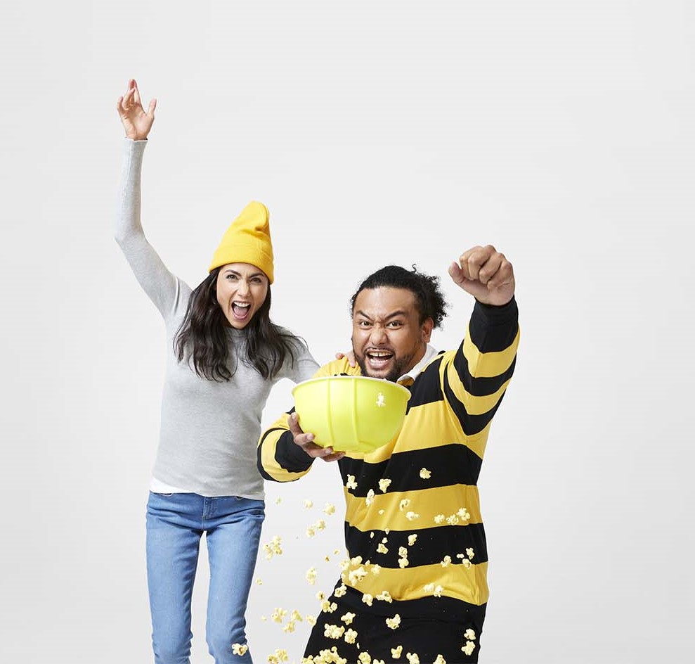 Man and women watching sport with popcorn