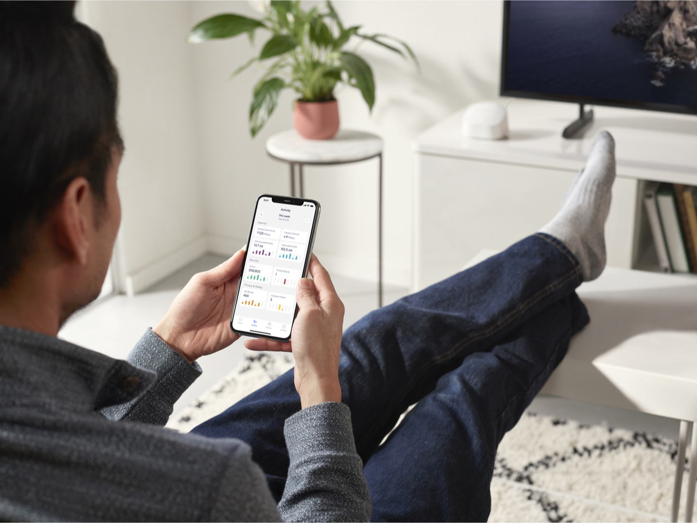 man on phone on a sofa managing eero ap