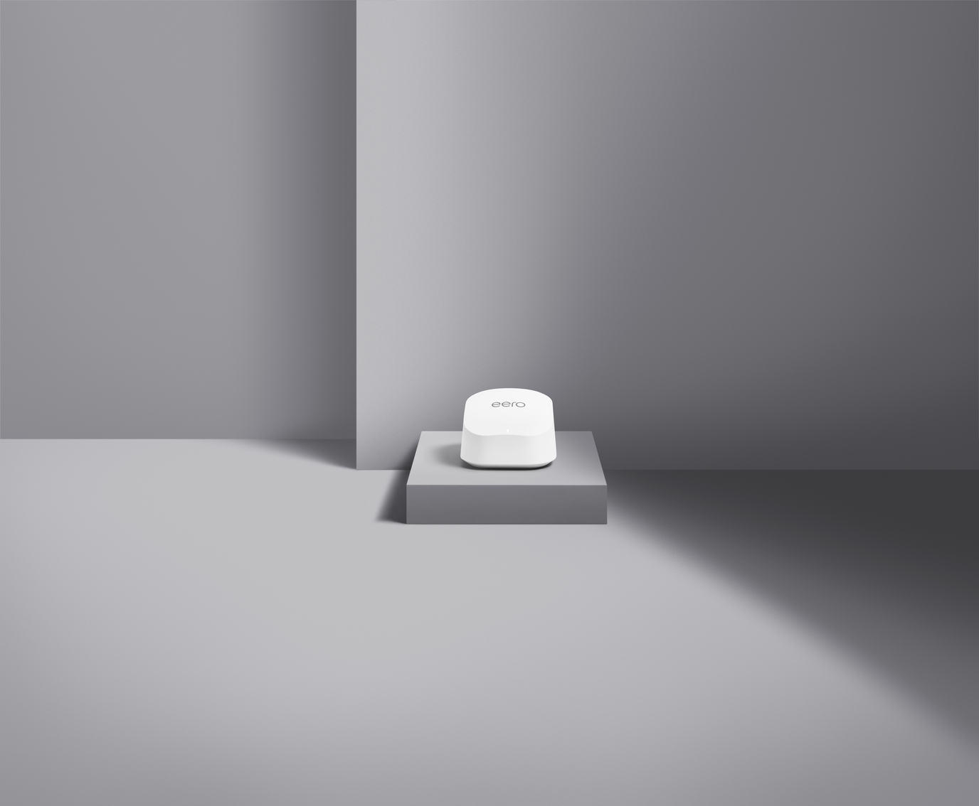 eero 6+ router device pictured against a grey background