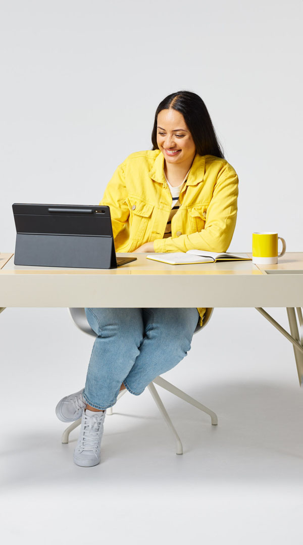 Women in yellow jacket working at desk