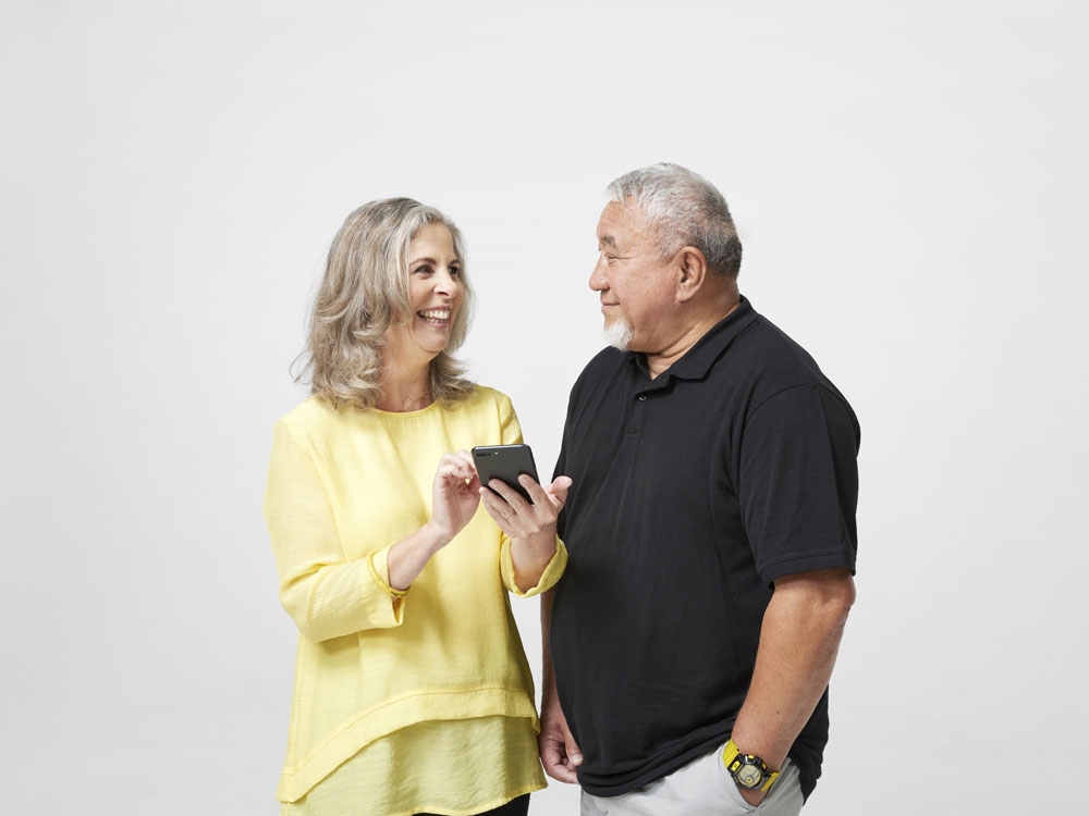 Happy man and woman couple looking at phone