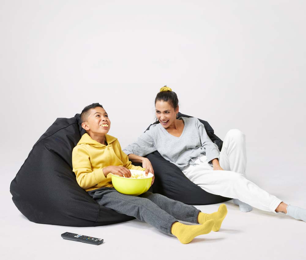 Mum and son eating popcorn, watching movie