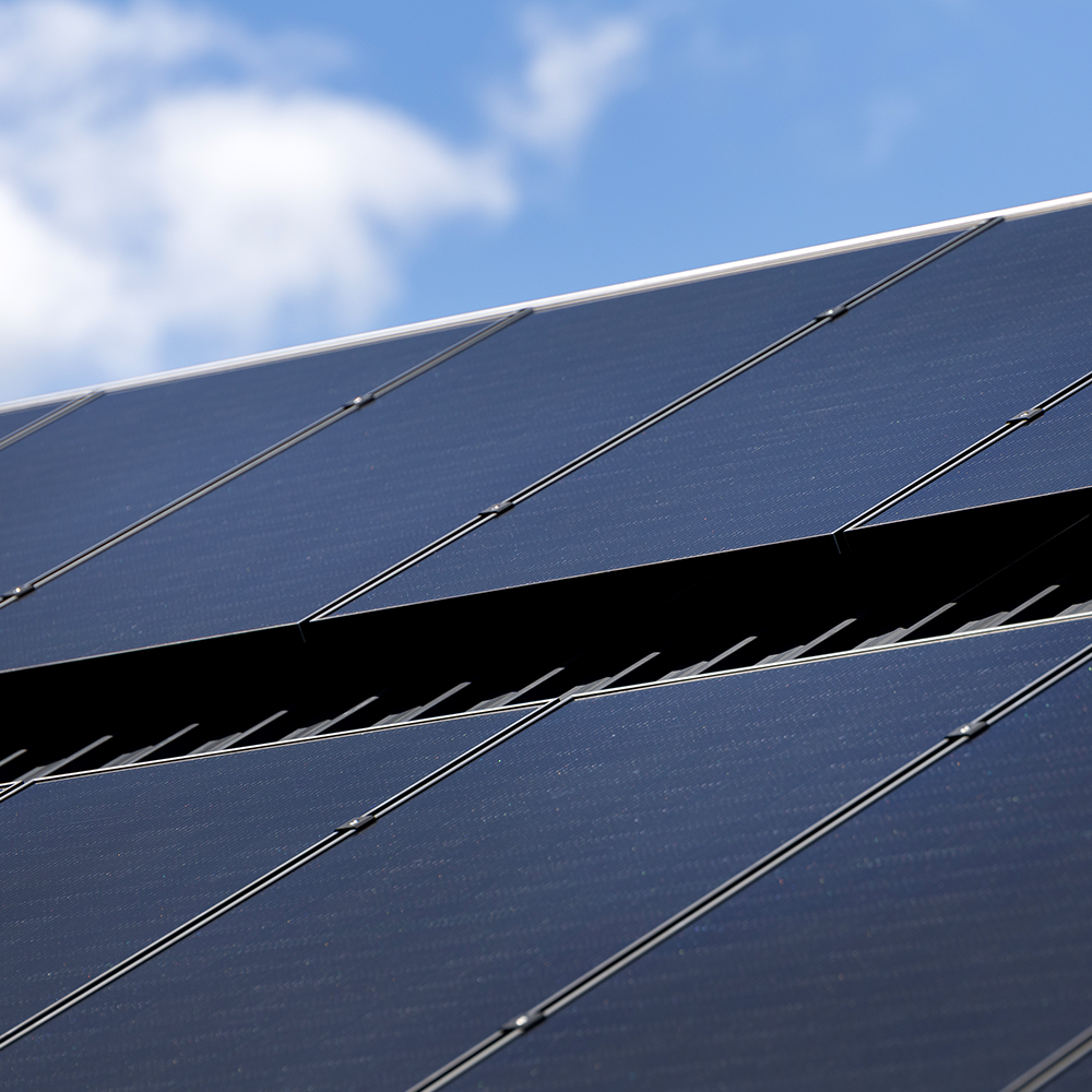 Solar panels on a roof, with a blue sky background.